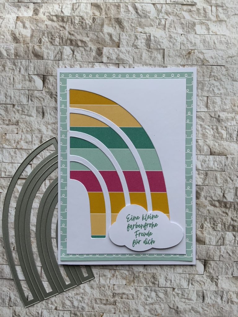 Stanzform „Farbenfroher Regenbogen“ mit Designpapier hinterlegt